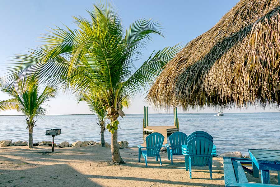 Tiki-hut, palm trees and beach chairs