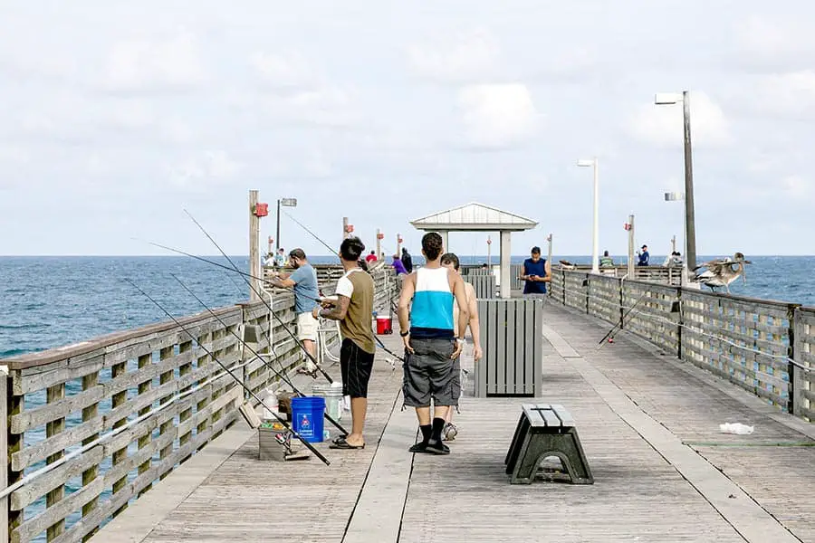 Fishermen fishing from wooden pier