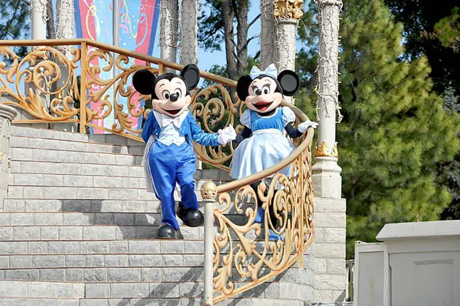 Mickey and Minnie Mouse walking down stairs