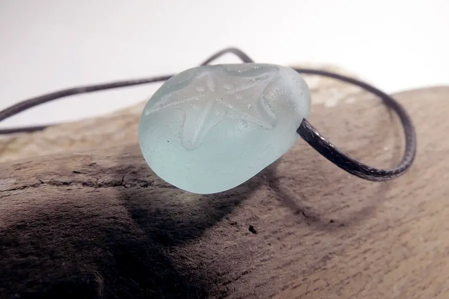 Starfish carved into sea glass pendant