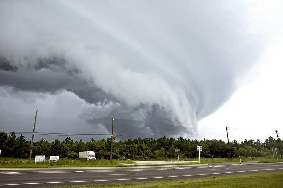 Semi truck passes by a tornado touching down in Florida