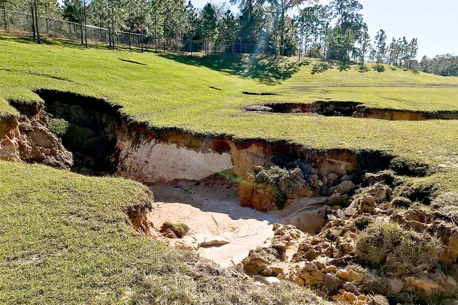 Detention pond drained dry by a sinkhole