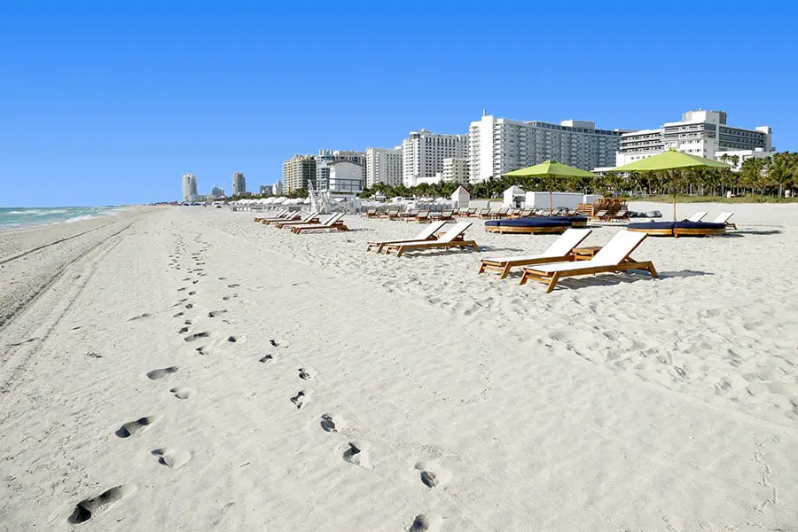White sand beach and Art Deco hotels along the coastline at South Beach