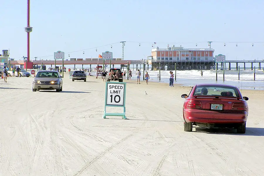 Cars driving on the hard packed sand at Daytona Beach