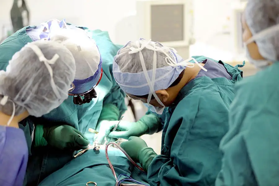 Team of operating room professionals performing operation