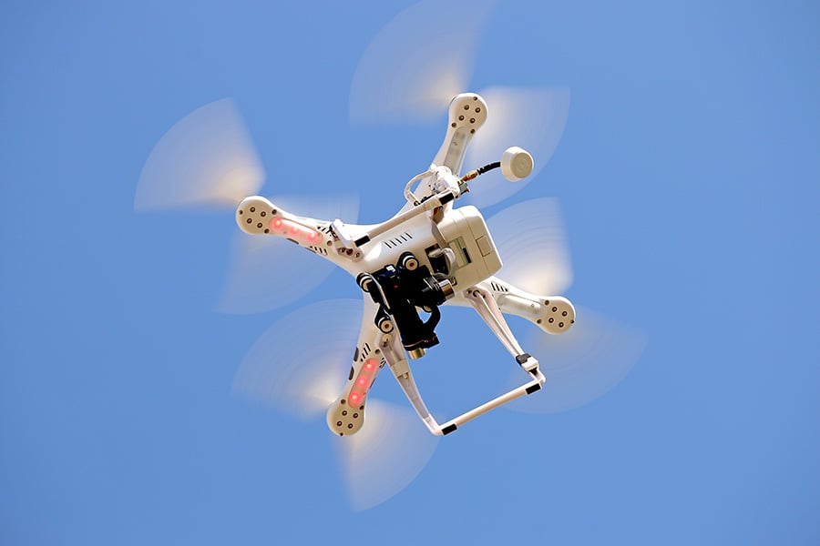 Drone flying against clear blue sky