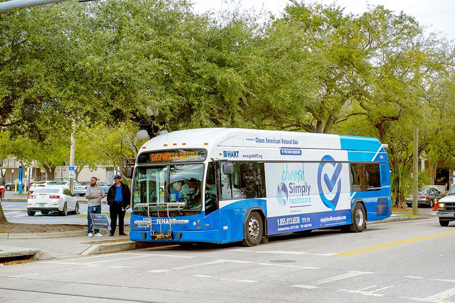 People boarding a blue and white Hillsborough Area Regional Transit bus