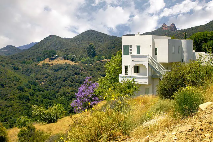 Large hillside home in California overlooking forested valley