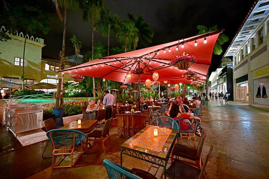 Red canopy over diners at outdoor restaurant in Miami