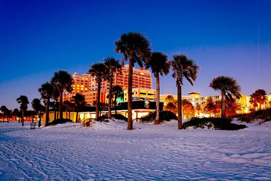 Clearwater Beach at dusk, known for it's white sand, palm trees and hotel in background