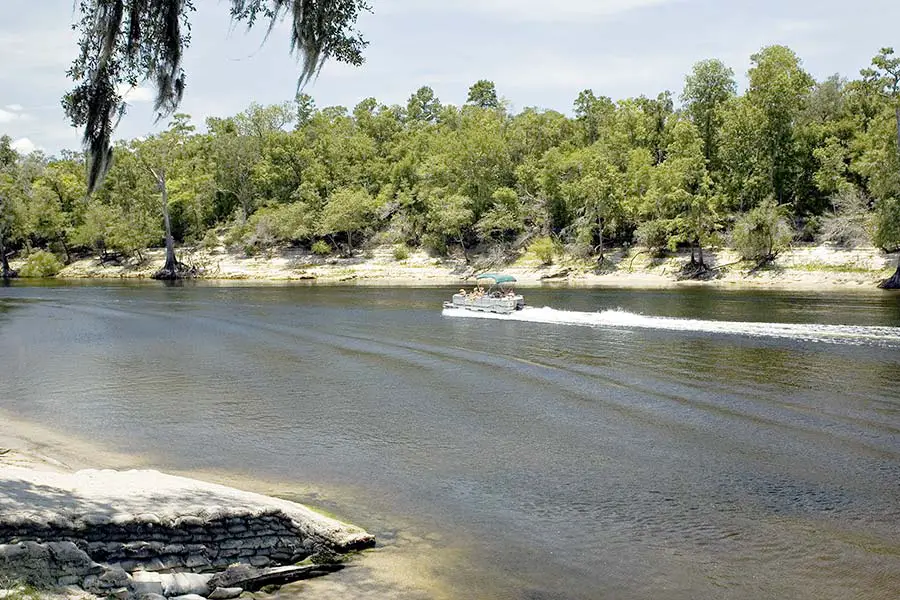 People in a pontoon boat heading up the Suwannee River