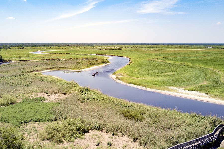 Aerial view of two boats navigating the Saint Johns River as it meanders across the landscape
