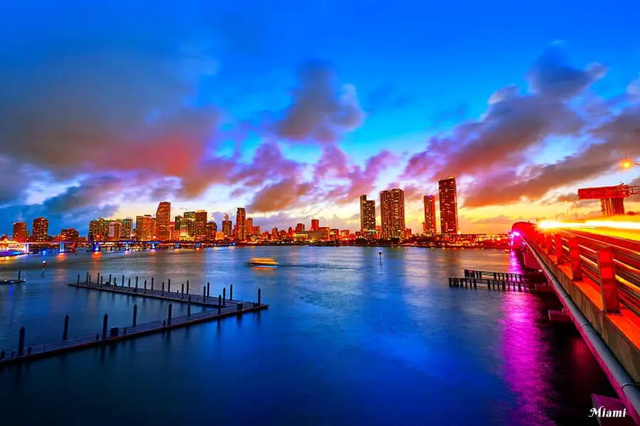 Sunset with blue sky and ocean, Miami skyline on the horizon