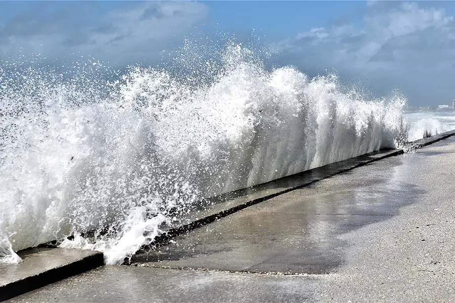 Wave crashing against wall during storm